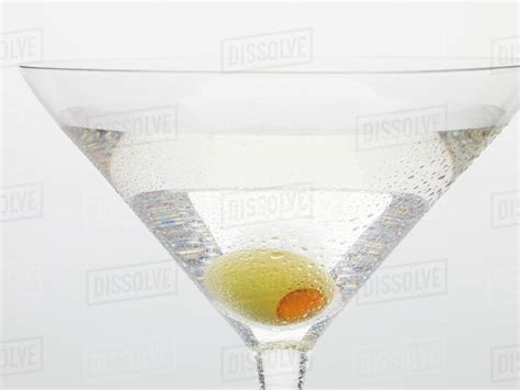 Martini with green olive (close-up) - Stock Photo - Dissolve