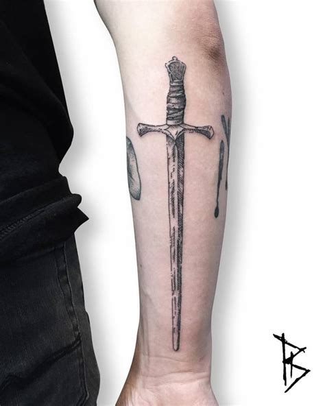 Engraving style sword tattoo on the right forearm.