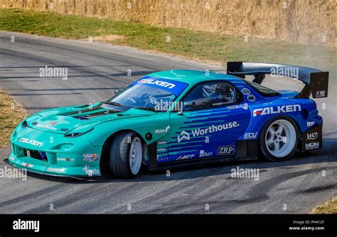 1995 Mazda RX-7 Formula Drift car with driver James Deane burning rubber at the 2018 Goodwood ...