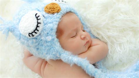 Cute Newborn Baby Is Sleeping On White Woolen Bed Wearing Knitted Woolen Blue Cap HD Cute ...