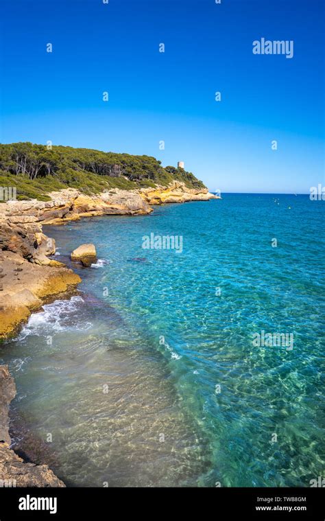 Cala de roca Plana beach in Tarragona beside Waikiki beach also Cala Fonda Stock Photo - Alamy