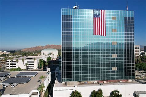 American Flag Hanging on a Glass Building · Free Stock Photo