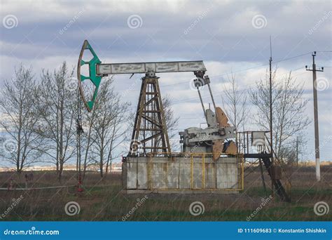 Oil Pumpjack among Grassy Field at Sunny Day Stock Image - Image of oilrig, pumpjack: 111609683