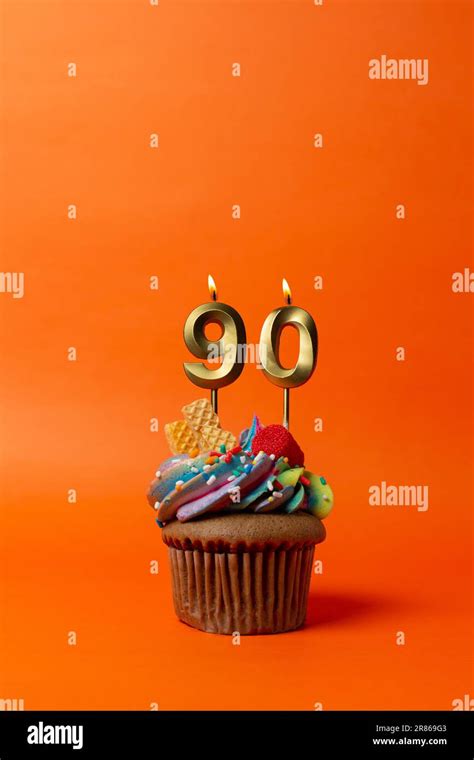 birthday cake with number 90 - cupcake on orange background with ...