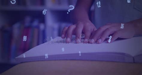 Digital Composition of Numbers and Symbols Floating Against Mid Section of Boy Reading a Book in ...