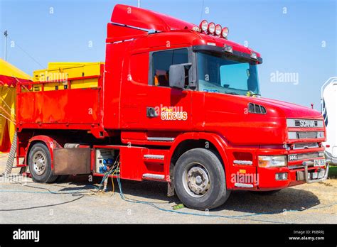 Scania lorry or truck painted bright red in circus colours supplying ...