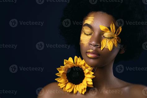 African woman with a sunflower and creative makeup on her face 16204021 ...