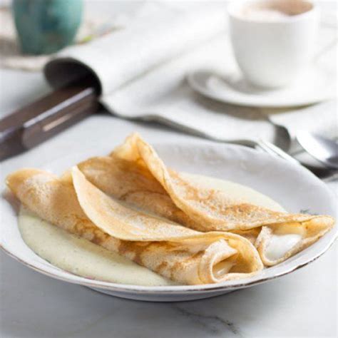 Traditional Austrian crêpes (Palatschinken) with cream cheese lemon filling and vanilla sauce ...