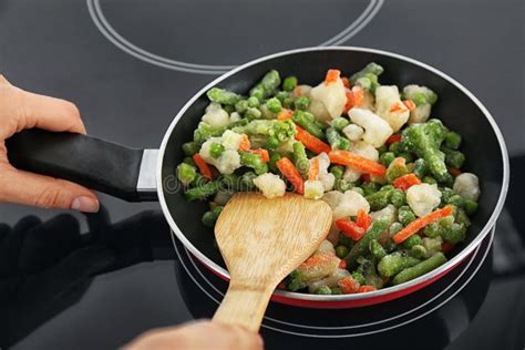 Woman Cooking Frozen Vegetable Mix on Induction Stove Stock Image - Image of freezer, carrots ...