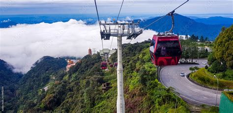 cable car at genting highlands, malaysia in a foggy weather with green grass visible from inside ...