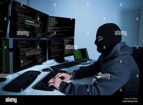 Hacker Using Computers With Multiple Monitors Stock Photo - Alamy