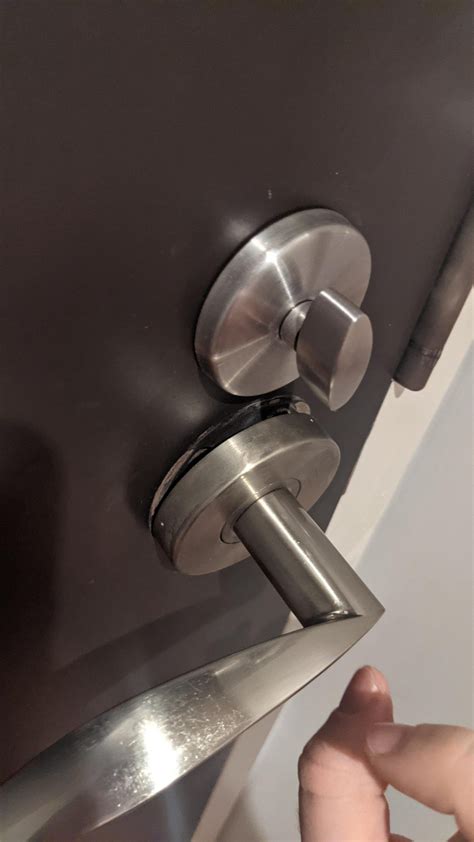 How to tighten this loose door knob with no visible screws?