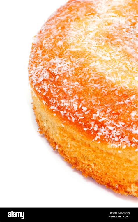 closeup of a coconut sponge cake on a white background Stock Photo - Alamy