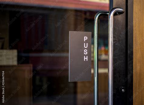 Restaurant door handle with push sign on glass doors Stock Photo | Adobe Stock