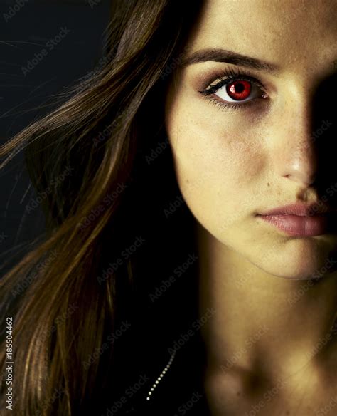 Portrait of beautiful vampire young woman with red eyes. Stock Photo ...