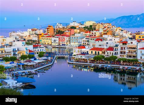 Agios Nikolaos, Crete, Greece: Sunset view of Agios Nikolaos over Voulismeni Lake, a picturesque ...