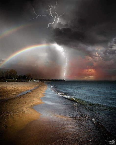 Lightning storm rainbow on a beach : r/pics