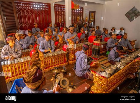 Locals playing Gamelan Saron Gangsa, traditional musical instruments ...