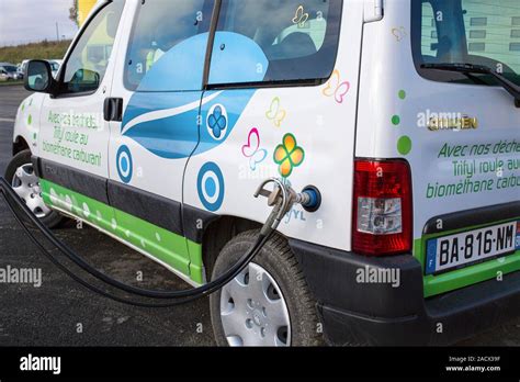 Biogas-powered car. Citroen Berlingo car being filled with biogas (methane and carbon dioxide ...