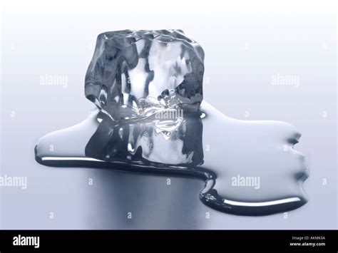 MELTING ICE CUBE WITH MELTED WATER Stock Photo: 2786873 - Alamy