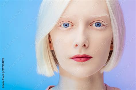 awesome beautiful albino with makeup and blue eyes looking at the ...