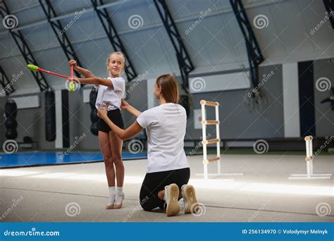 Little Girls, Beginner Gymnastics Athletes Doing Exercises with Gymnastics Equipment at Sports ...