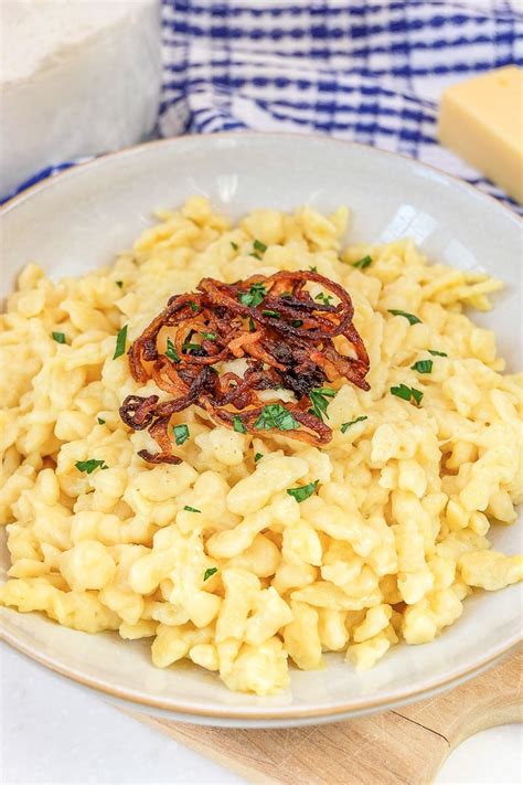 Want to make delicious and cheesy Käsespätzle? This classic German cheese spaetzle recipe is ...