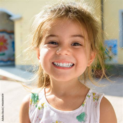 Cute and young little girl smiling Stock Photo | Adobe Stock