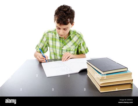 Caucasian student boy at his desk writing for homework Stock Photo - Alamy