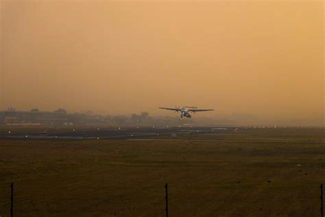 A plane taking off from an airport runway photo – Free Aircraft Image ...