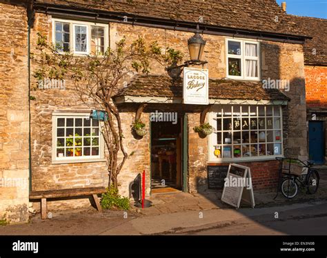 Traditional old fashioned exterior of village bakery shop at Lacock, Wiltshire, England, UK ...