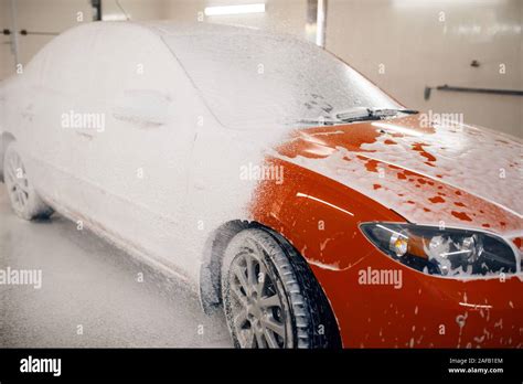 Automobile in foam, car wash service concept Stock Photo - Alamy