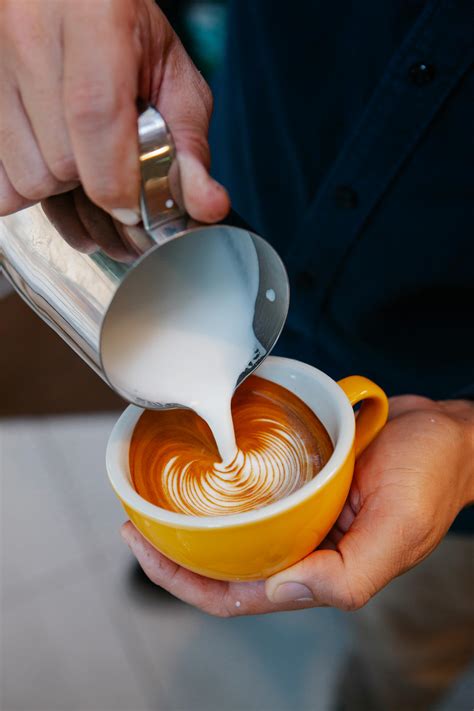 Man creating latte art with cream · Free Stock Photo