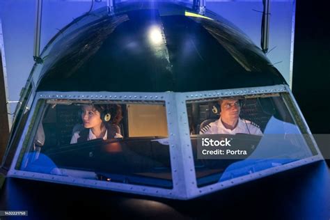 Pilot And A Trainee Copilot Sitting The Cockpit Of A Flight Simulator ...