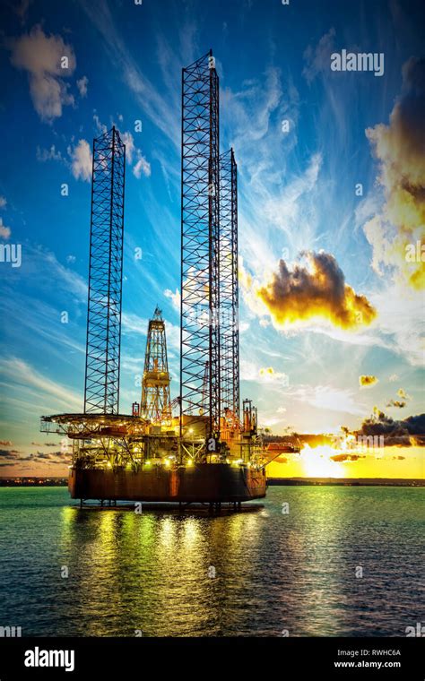 Oil drilling rig in sunset time Stock Photo - Alamy