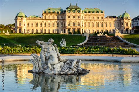 Famous Belvedere castle (Schloss Belvedere) surrounded by gardens with fountains and classic ...