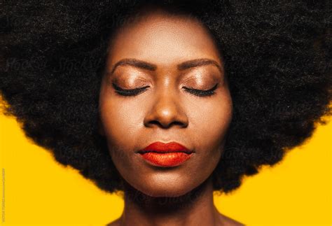 "Beautiful Afro Woman Posing Over Yellow Background With Eyes Closed" by Stocksy Contributor ...