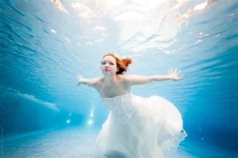 "Trash The Dress Underwater Beautiful Bride Swimming In Wedding Dress" by Stocksy Contributor ...