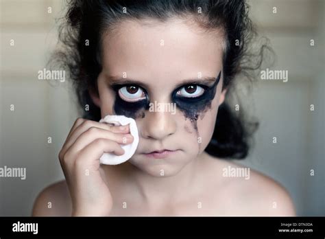 A young girl crying with black makeup with a gaze looking towards Stock Photo: 66846566 - Alamy