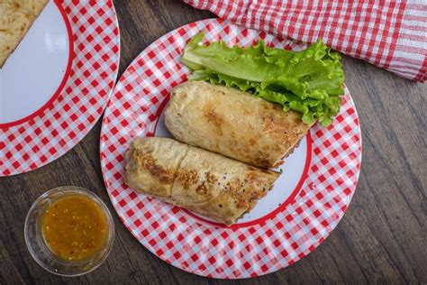 Premium Photo | Burrito on a plate on a wooden table typical mexican food