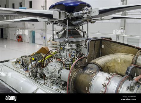 Helicopter gas-turbine engine with the cowling opened for maintenance in hangar Stock Photo - Alamy