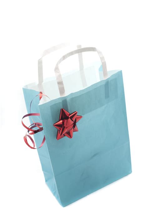 Free Stock Photo 8633 Blue gift paper bag decorated with a red shiny bow | freeimageslive