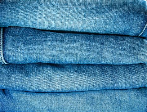 Pile of blue jeans, fabric texture 16655801 Stock Photo at Vecteezy