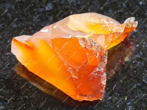 Premium Photo | Rough carnelian chalcedony gemstone on dark