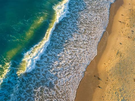 drone view of ocean waves crashing on the sand beach at roker beach, summer sunrise waves 4k HD ...