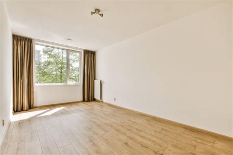 Premium Photo | An empty living room with wood floor and large window ...