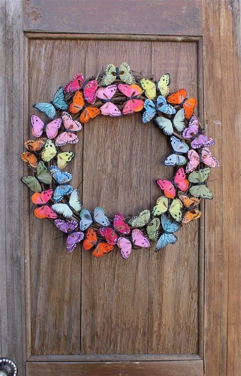 This bright and colorful wreath flaunts many vibrant feather butterflies arranged in a circular ...