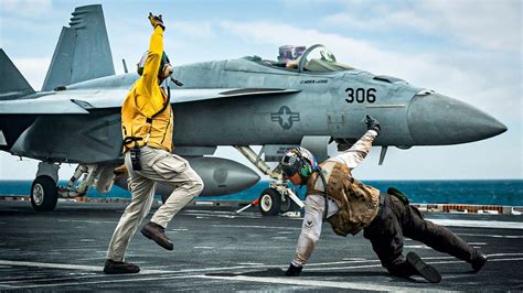 The Insane Hand Signals on an Aircraft Carrier's Flight Deck Explained - YouTube