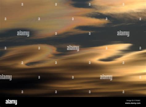 Altocumulus lenticularis clouds with rainbow colors at sunset Stock Photo - Alamy