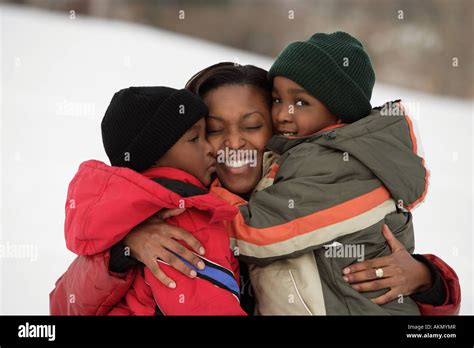 Mother hugging her children Stock Photo - Alamy